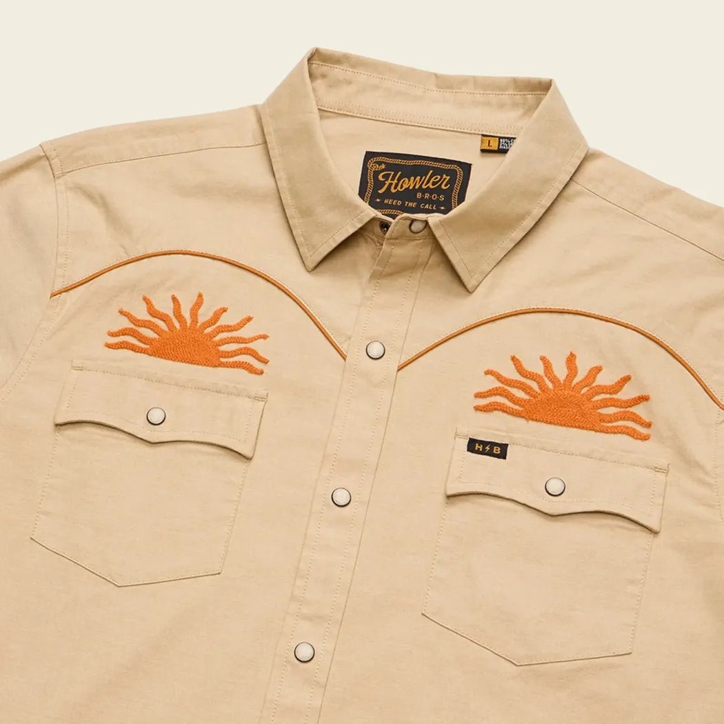 A front view of the Howler Brothers Men's Crosscut Deluxe Longsleeve in El Sol : Gold showing the sun embroidery and chest pockets against a plain background.