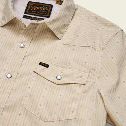 A close-up of the Howler Brothers Men's H Bar B Tech Longsleeve in Supernova Stripe : Leche showing the chest pocket and button placket against a neutral background.