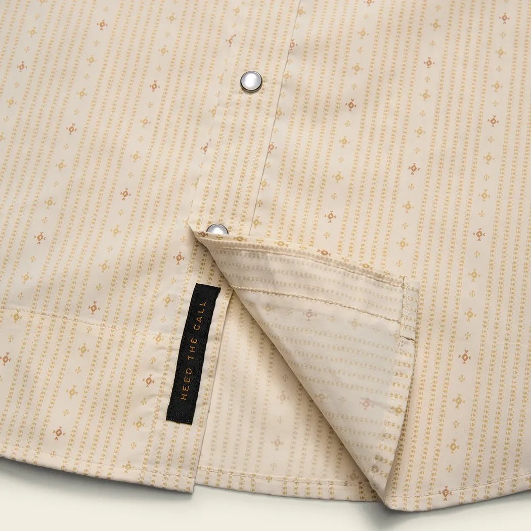 A close-up of the Howler Brothers Men's H Bar B Tech Longsleeve in Supernova Stripe : Leche showing the collar and a black tag.