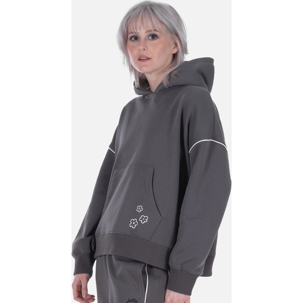 Side view of the Jetty Womens Wren Hoodie in Charcoal showing the front pocket with small white flowers against a plain white background.