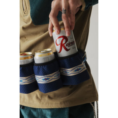 Close-up of the Kavu Beer Buddy in Park Lines holding three cans, with a hand reaching for the top one.