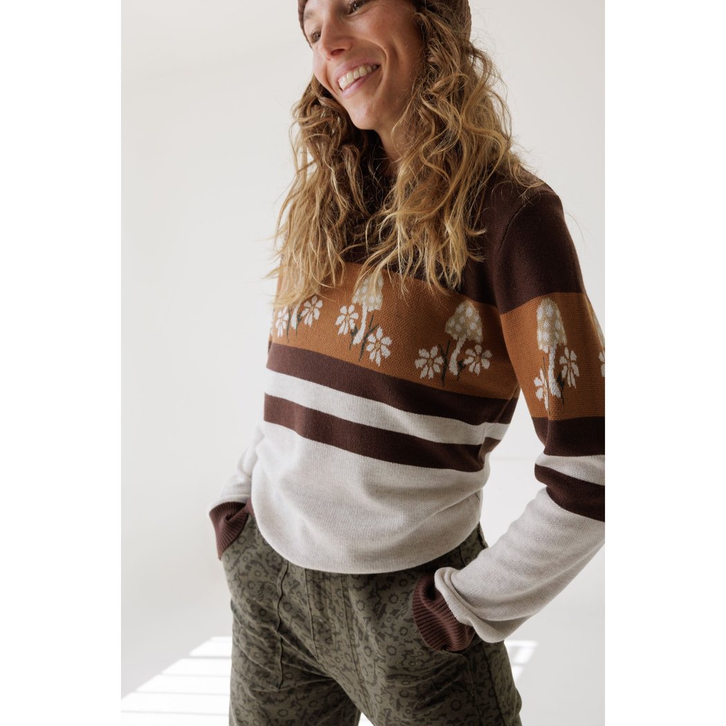 Model wearing the Kavu Hillrose in Forage Patch with hands in pockets against a white background.