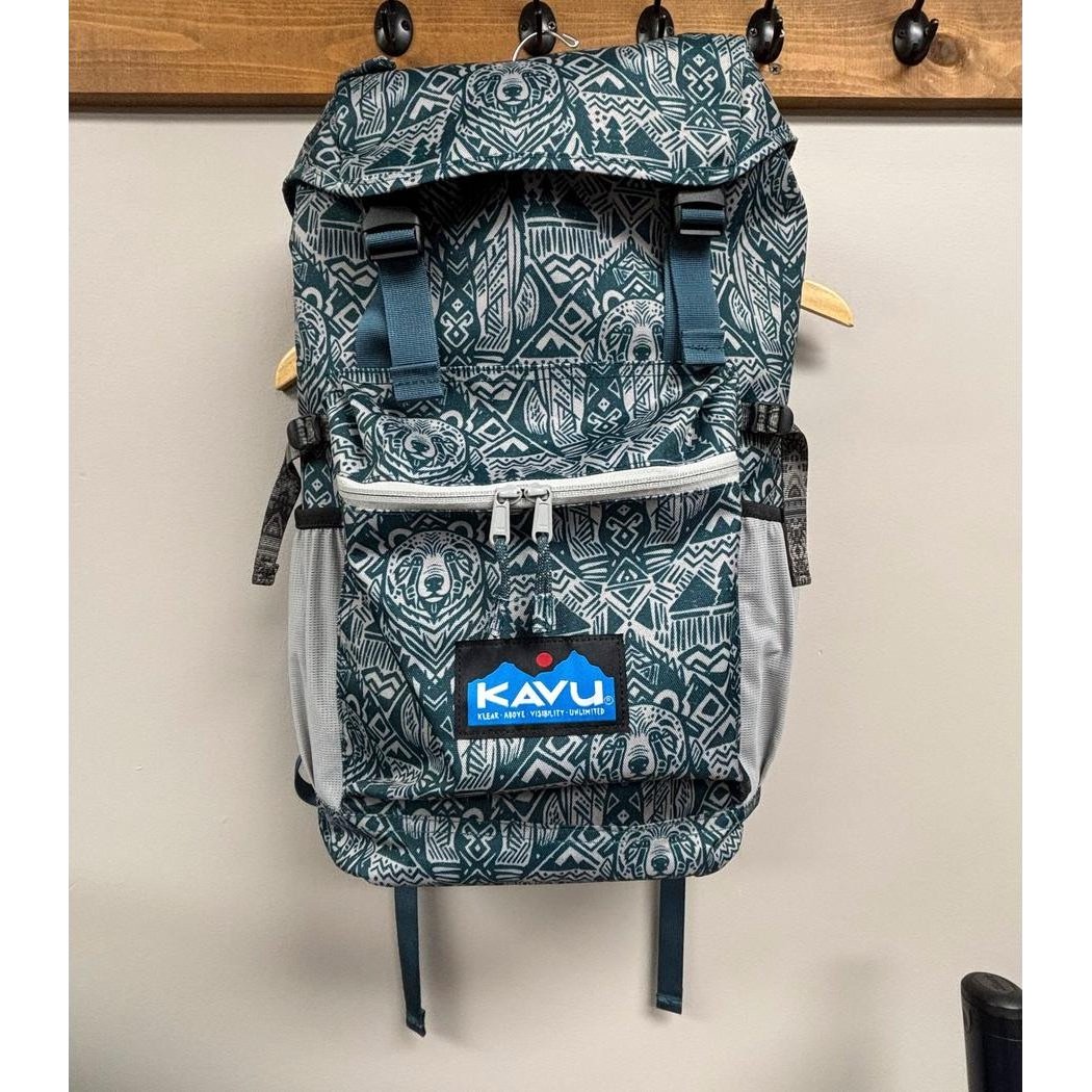 A front view of the Kavu Timaru backpack in Forest Pass hanging on a wall hook.