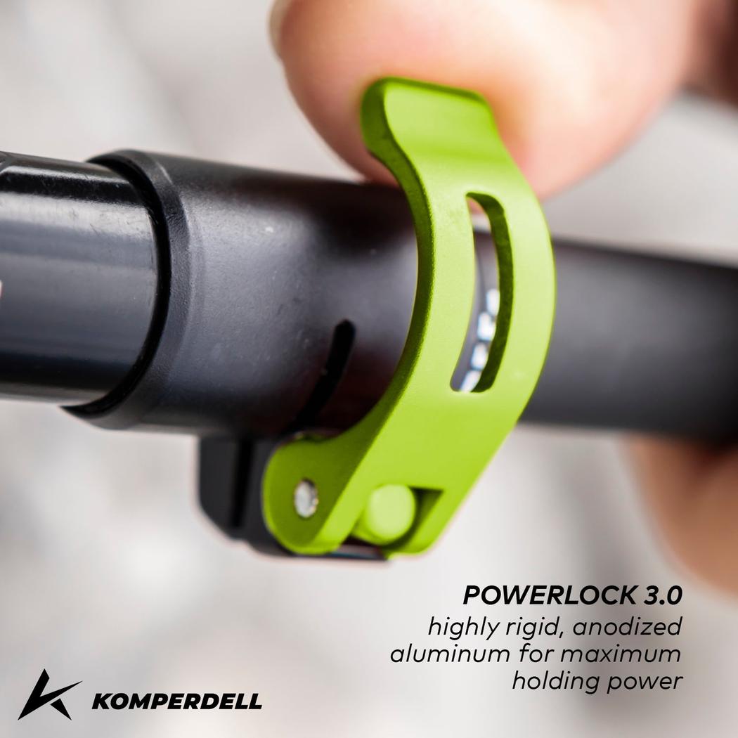 A close-up of a Komperdell Powerlock 3.0 green clip on a black trekking pole, showing the anodized aluminum feature.