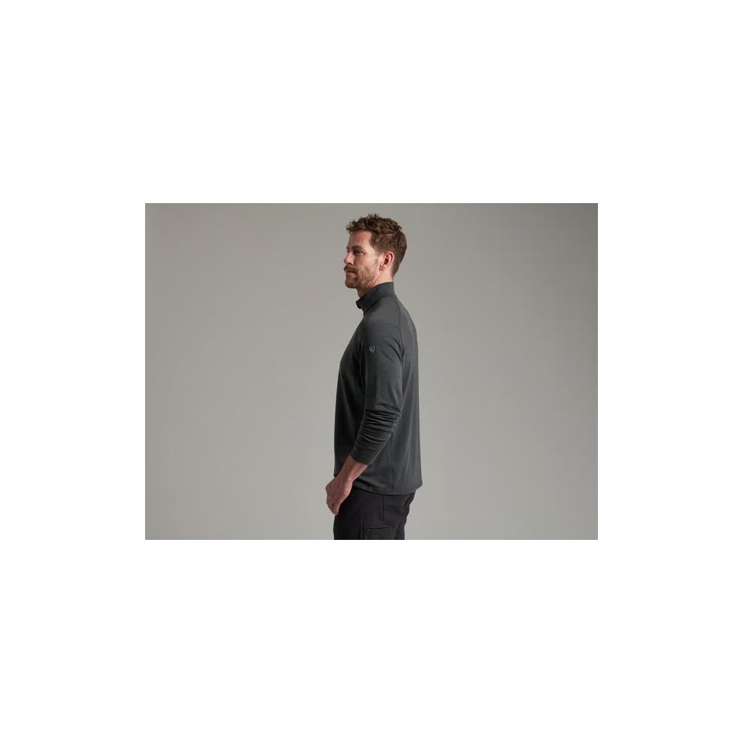 Side view of the Kuhl Mens Influx 1/4 Zip in Carbon showing a model wearing it against a gray background.