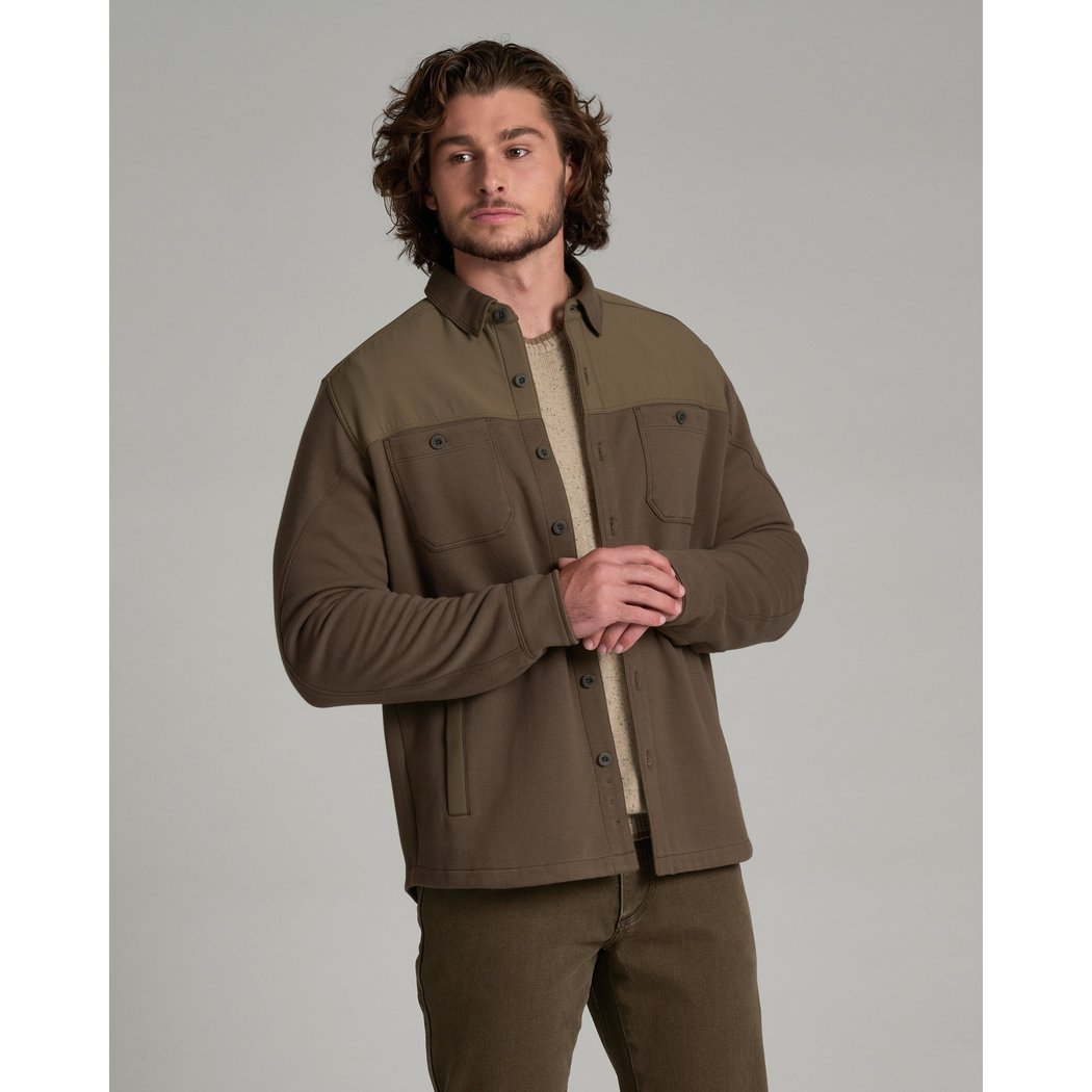 Front view of the Kuhl Relentr™ Shirt-Jac in Kanteen on a man with curly hair against a gray background.