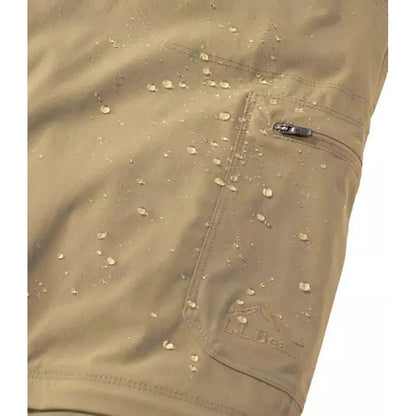 A close-up of the L.L.Bean Men's Cresta Hiking Zip Off Pant in Dark Cinder showing water droplets on the fabric and a zippered pocket.