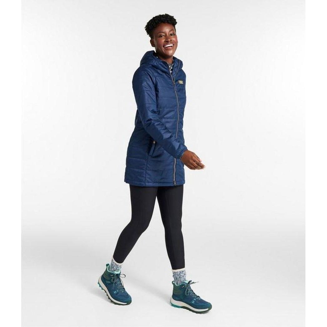 Side view of the L.L.Bean Women's Mountain Classic Puffer Coat in Nautical Navy on a model against a white background.