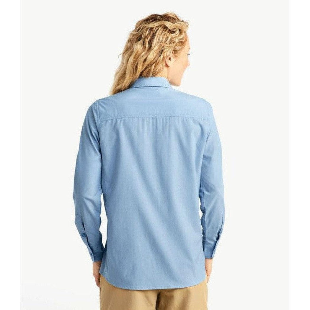 Back view of the L.L.Bean Women's Regular No Fly Zone Shirt Long-Sleeve in Blue Aster on a model wearing khaki pants against a white background.