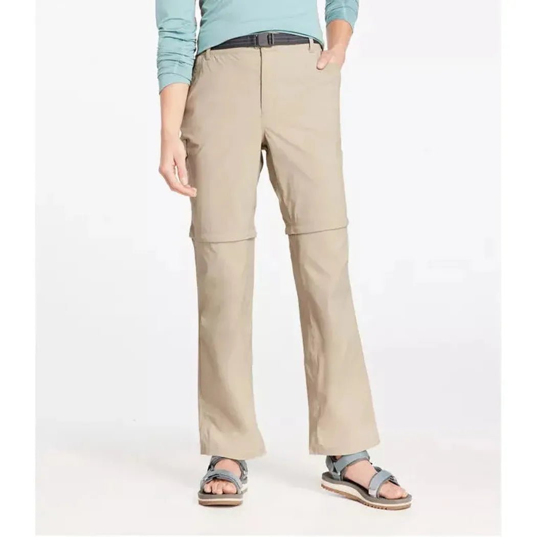 A front view of the L.L.Bean Women's Tropicwear Zip-Off Pants, Mid-Rise in Soft Sand, showing the zip-off feature and a model wearing them against a white background.