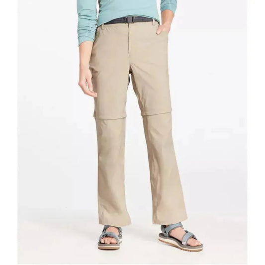 A front view of the L.L.Bean Women's Tropicwear Zip-Off Pants, Mid-Rise in Soft Sand, showing the zip-off feature and a model wearing them against a white background.