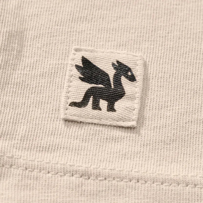 A close-up of the Life is Good Women's Collection of Mushrooms Short Sleeve Crusher Tee in Birch White showing the embroidered mushroom logo on the chest.