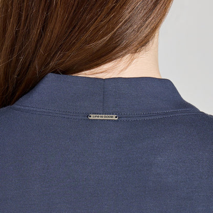 Back view of the Life is Good Women's Solid Soft Touch Open Cardigan in Inkwell Blue showing the brand tag on the collar.