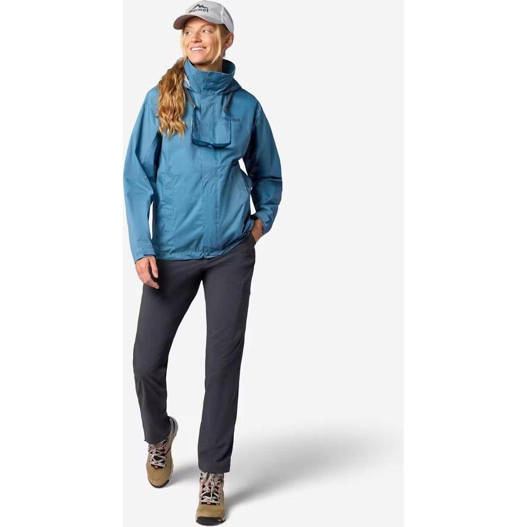 A woman wearing the Marmot Women's PreCip Evo Jacket in Summer Storm stands against a plain white background.
