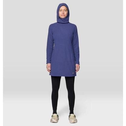 A front view of the Mountain Hardwear Women's Summit Grid Dress in Bourbon Brown on a model wearing black leggings and light-colored shoes against a plain background.