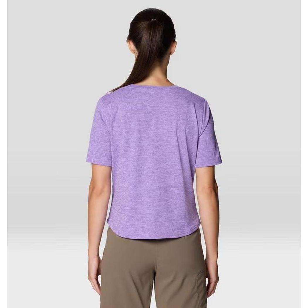 Back view of the Mountain Hardwear Women's Sunblocker Short Sleeve in Harbor Violet on a model wearing khaki pants against a light gray background.