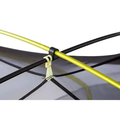 A close-up of the NEMO Dagger OSMO Lightweight Backpacking 2p Tent showing the yellow and black frame against a gray background.