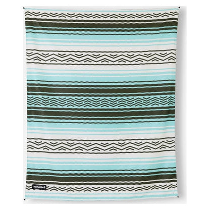 Flat view of the Nomadix Festival Blanket in Baja Aqua showing its striped pattern and hanging loops.