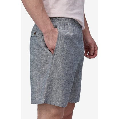 Side view of the Patagonia Men's Baggies Naturals in Chambray: Feather Grey showing the front pocket and model wearing it against a white background.