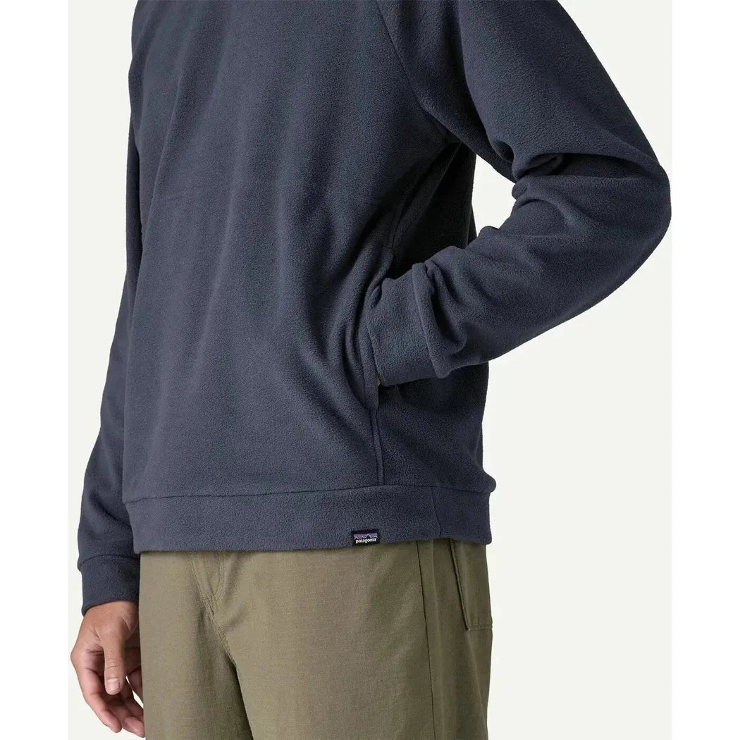 Side view of the Patagonia Men's Micro D Crewneck in Basin Green showing the model wearing it against a plain background.