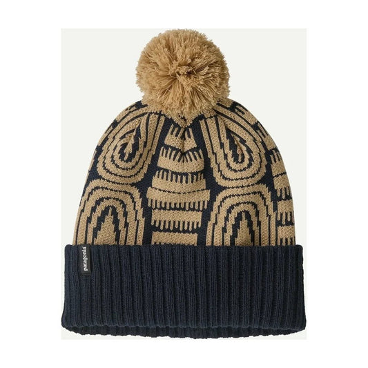 A front view of the Patagonia Powder Town Beanie in Flow: Sunken Blue with a tan pom pom and a dark ribbed cuff, against a white background.