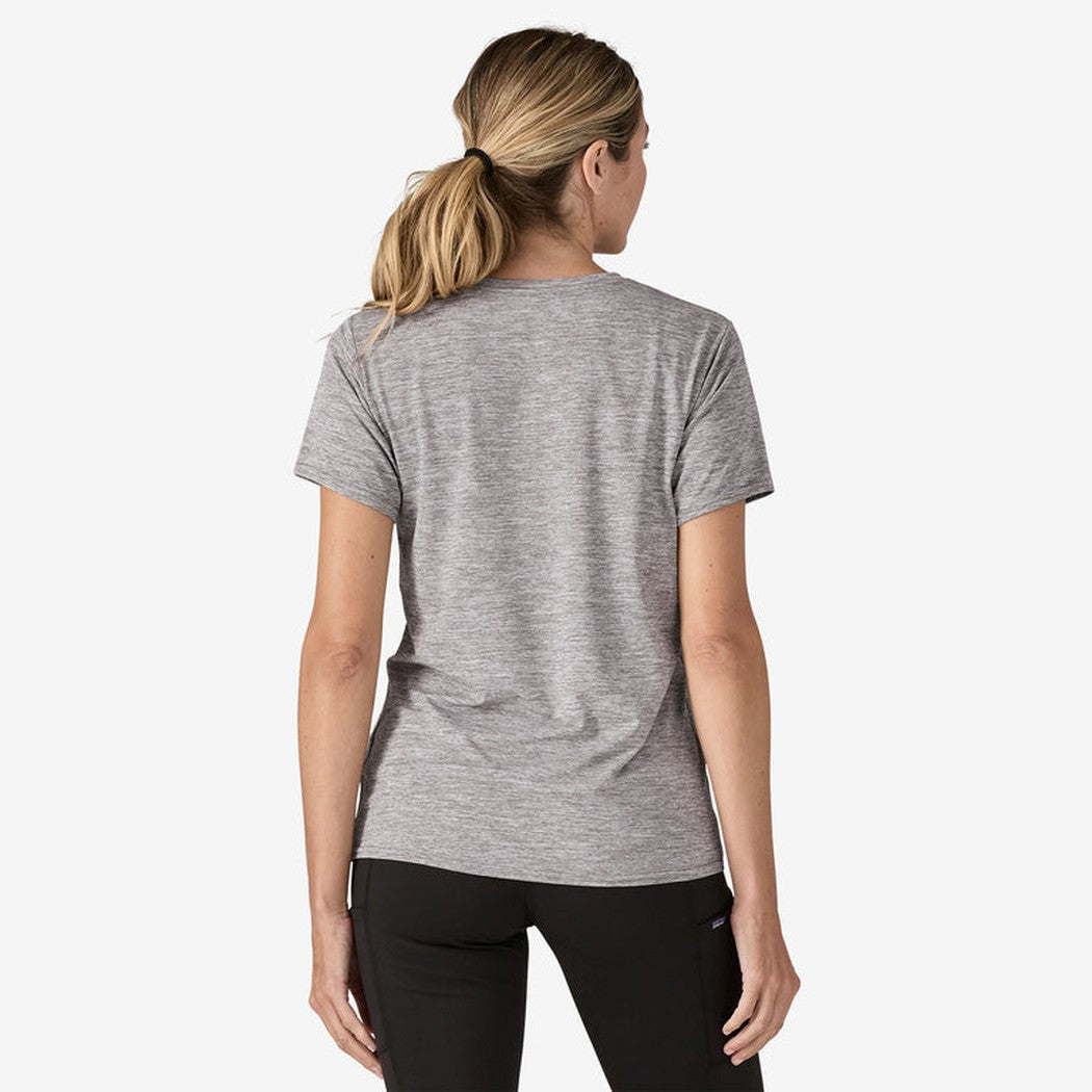 Back view of the Patagonia Women's Cap Cool Daily Shirt in Feather Grey on a model wearing black pants against a white background.