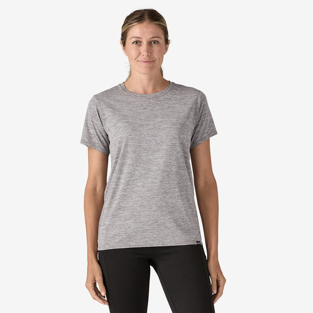 A front view of the Patagonia Women's Cap Cool Daily Shirt in Feather Grey on a model wearing black pants against a white background.
