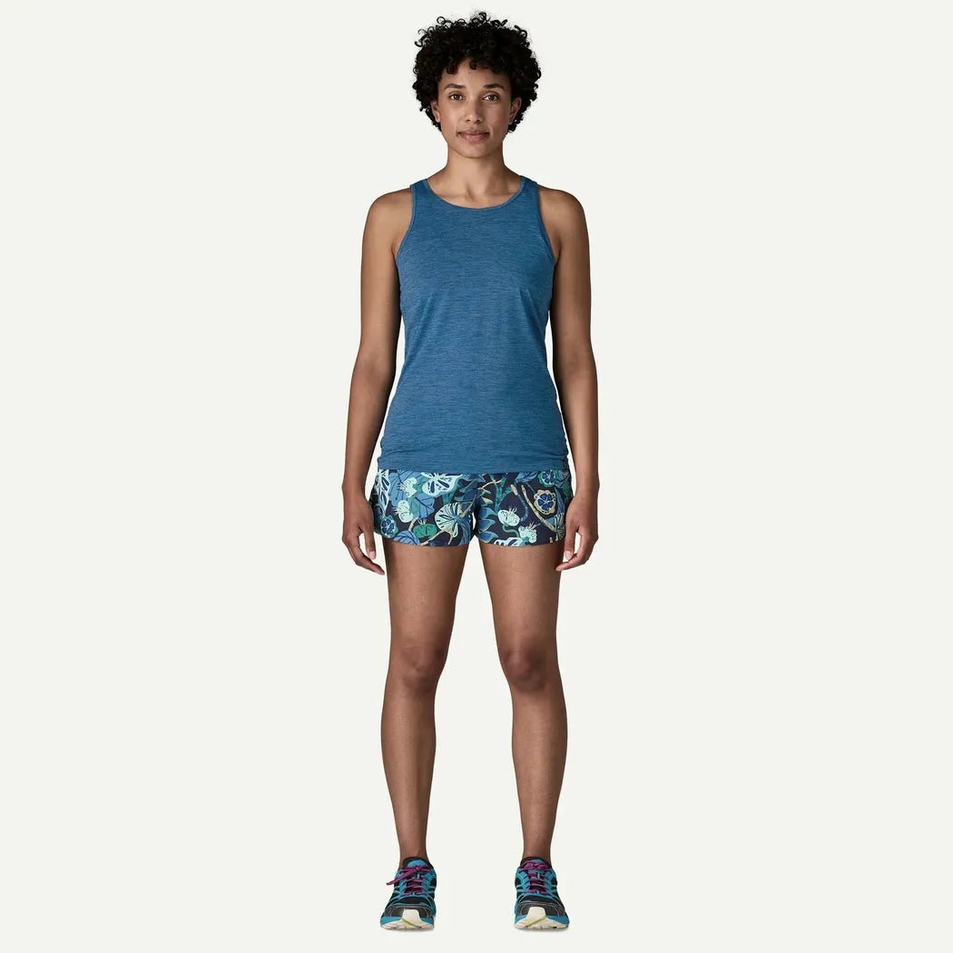 A front view of the Patagonia Women's Cap Cool Daily Tank in Aquatic Blue - Light Aquatic Blue X-Dye on a model against a white background.