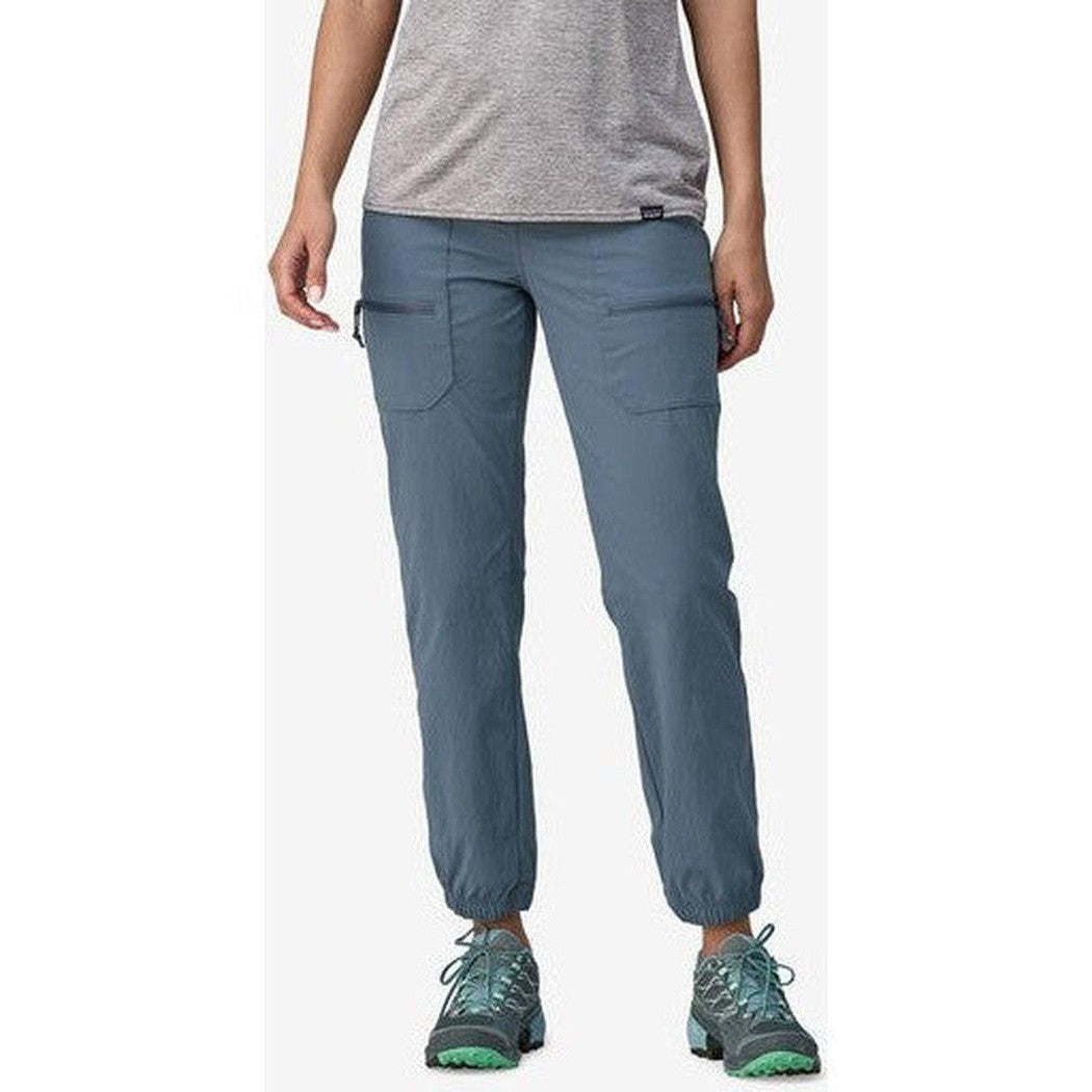 A front view of the Patagonia Women's Quandary Joggers in Forge Grey showing the elastic cuffs and pockets on a model wearing teal sneakers against a white background.