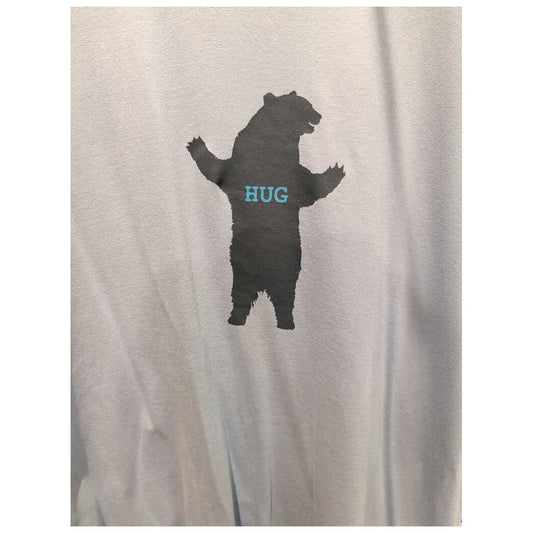 Front view of the Prana Mens Bear Squeeze Journeyman SS Tee-SAMPLE in Glacier Sky showing a bear silhouette with "HUG" on the chest against a light background.