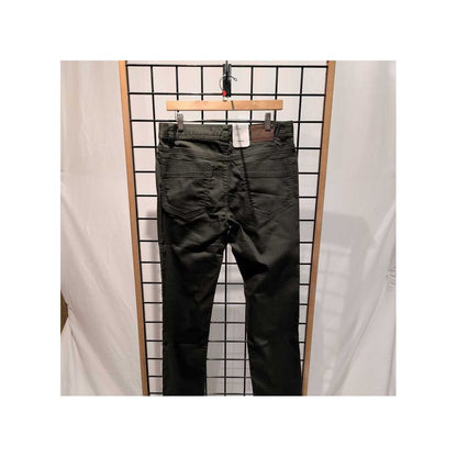 Back view of the Prana Mens Bridger Jeans-SAMPLE in Spruce/32 hanging on a grid display with a white backdrop.