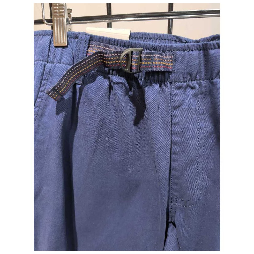 Close-up of the Prana Mens Durado Pant-SAMPLE in Capulet Blue showing the elastic waistband and belt loop with a metal clip on a grid background.