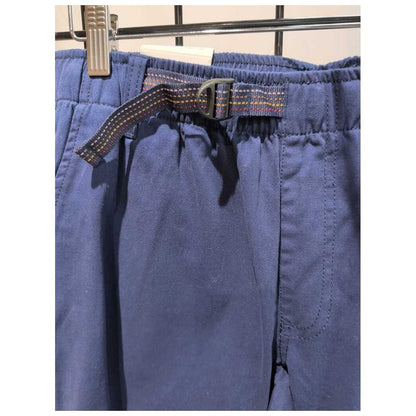 Close-up of the Prana Mens Durado Pant-SAMPLE in Capulet Blue showing the elastic waistband and belt loop with a metal clip on a grid background.