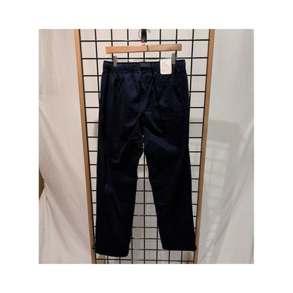 Front view of the Prana Mens Durado Pant-SAMPLE in Capulet Blue hanging on a wooden hanger against a grid background.