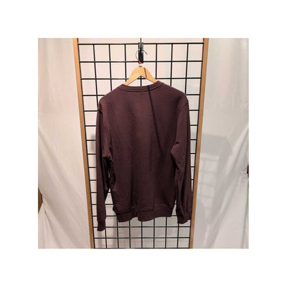 Back view of the Prana Mens Everyday Crew Sweatshirt-SAMPLE in DeepVino hanging on a wooden hanger against a grid wall.