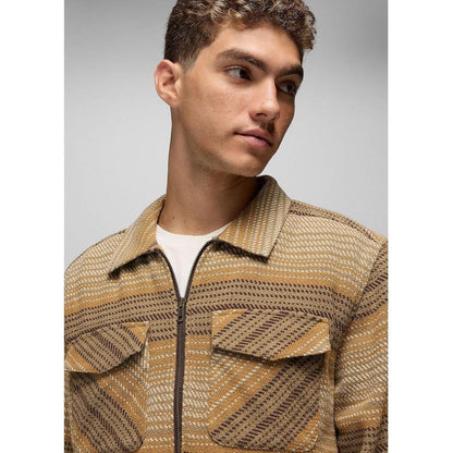 A side view of the Prana Men's Heritage Zip Flannel in Dark Roast showing the front pockets and zipper against a light background.