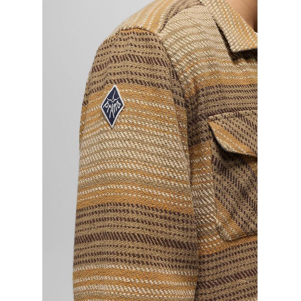 A close-up of the Prana Men's Heritage Zip Flannel in Dark Roast showing the shoulder patch and chest pocket against a light background.