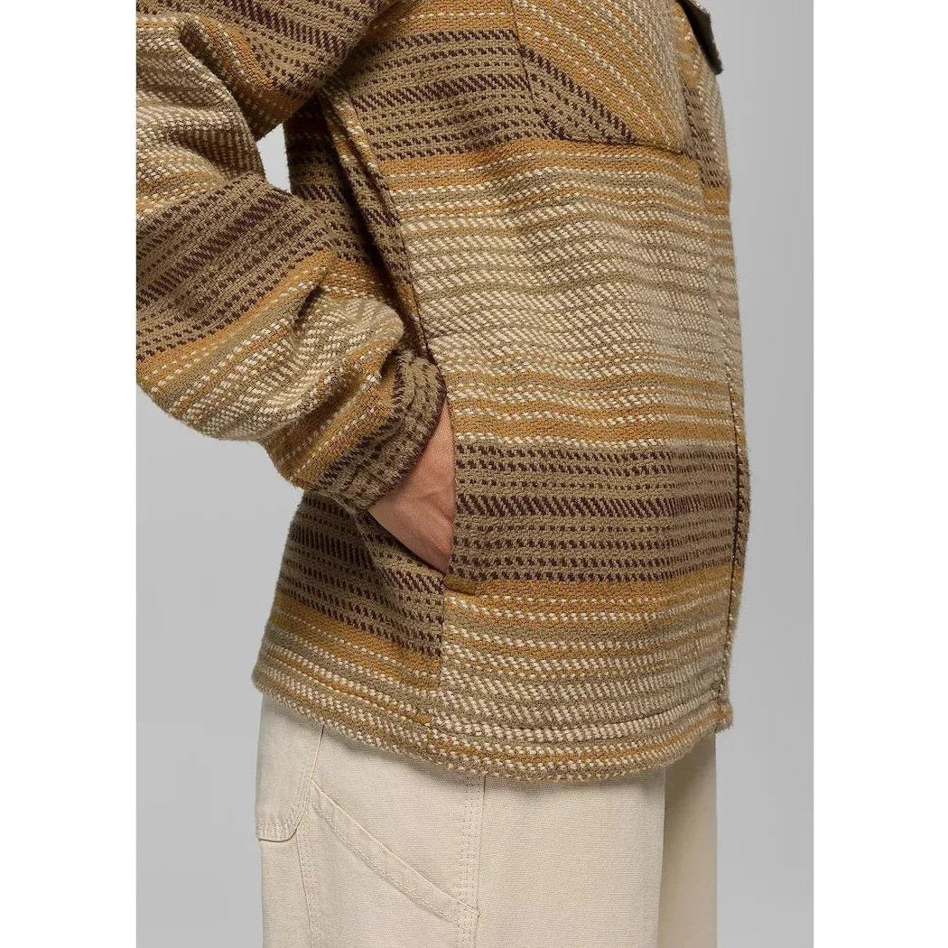 Side view of the Prana Men's Heritage Zip Flannel in Dark Roast showing the front pocket and beige pants against a light background.