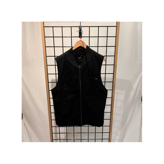 Black Prana Mens Rock Ridge Vest-SAMPLE hanging on a grid wall with a wooden hanger.