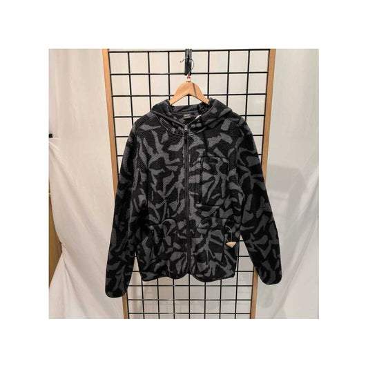 Front view of the Prana Mens Tuff Fluff Full Zip-SAMPLE in Shadow Freestyl hanging on a wooden hanger against a grid backdrop.