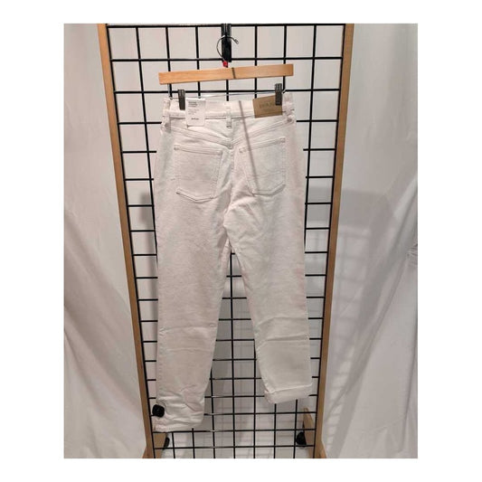 Back view of the Prana Womens Carlsbad 760 Straight Jean 26'-SAMPLE in White Sand hanging on a grid display with a wooden hanger.