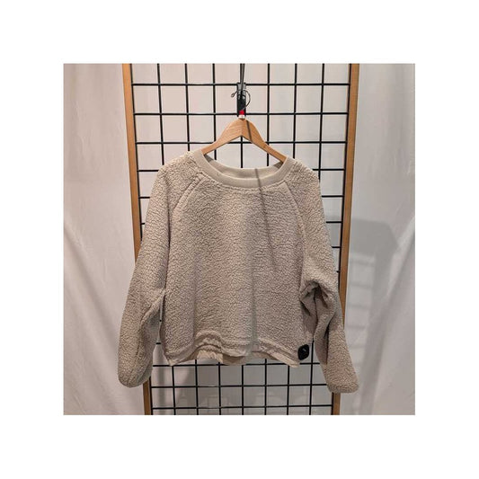 Front view of the Prana Womens Encinitas Sherpa Crew-SAMPLE in Almond hanging on a wooden hanger against a grid backdrop.