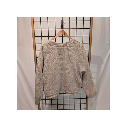 Back view of the Prana Womens Encinitas Sherpa Crew-SAMPLE in Almond hanging on a wooden hanger against a grid background.