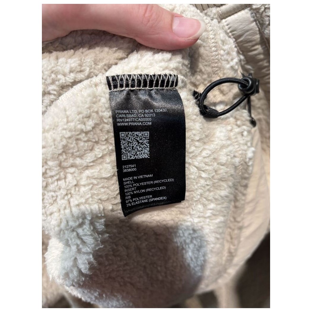 Close-up of the Prana Womens Encinitas Sherpa Crew-SAMPLE in Almond showing the black care tag and drawstring detail.