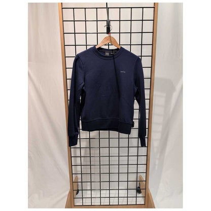 Navy Prana Womens Everyday Crew Sweatshirt-SAMPLE hangs on a wooden hanger against a grid display with a white backdrop.