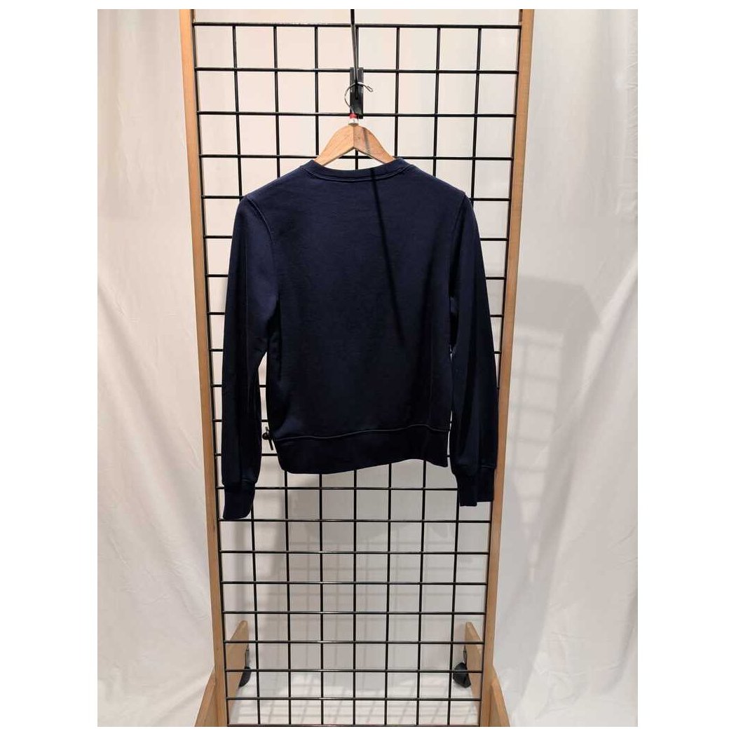 Back view of the Prana Womens Everyday Crew Sweatshirt-SAMPLE in Canvas hanging on a wooden hanger against a grid background.