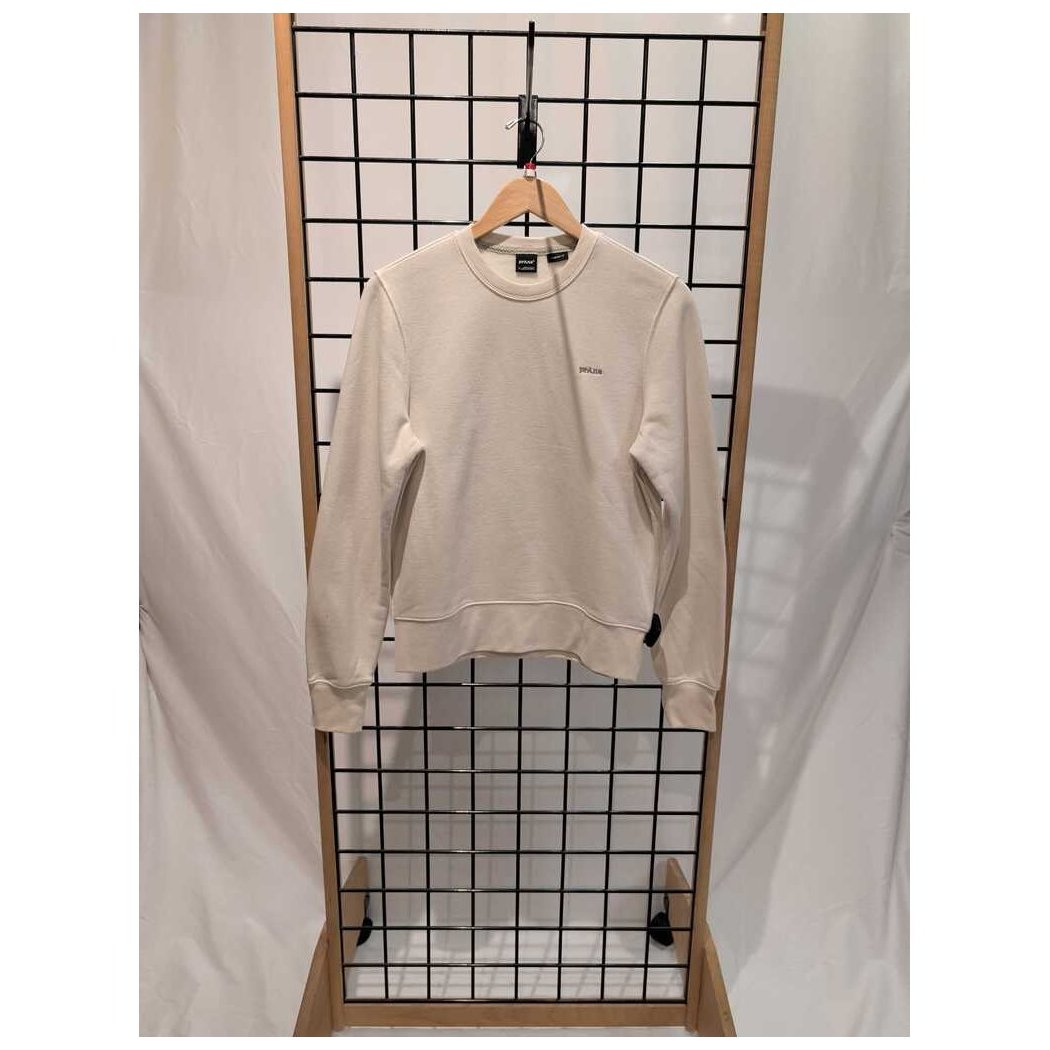 Canvas Prana Womens Everyday Crew Sweatshirt-SAMPLE hangs on a wooden hanger against a grid display with white drapes.