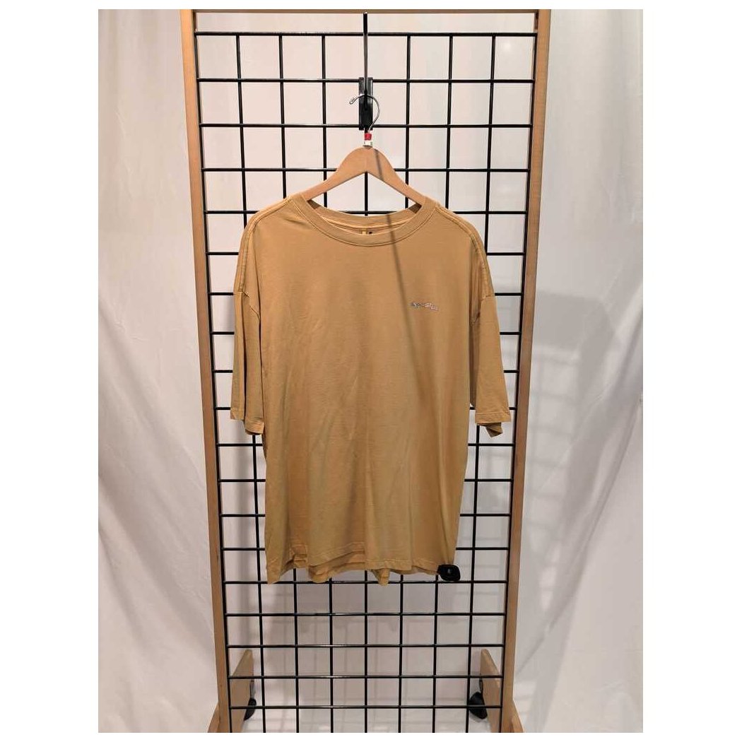 Front view of the Prana Womens Everyday Graphic Oversized Tee-SAMPLE in Dijon Vacation hanging on a grid display with a wooden frame.