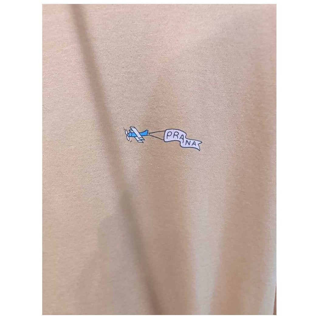 Close-up of the Prana Womens Everyday Graphic Oversized Tee-SAMPLE in Dijon Vacation showing the small airplane graphic on the fabric.