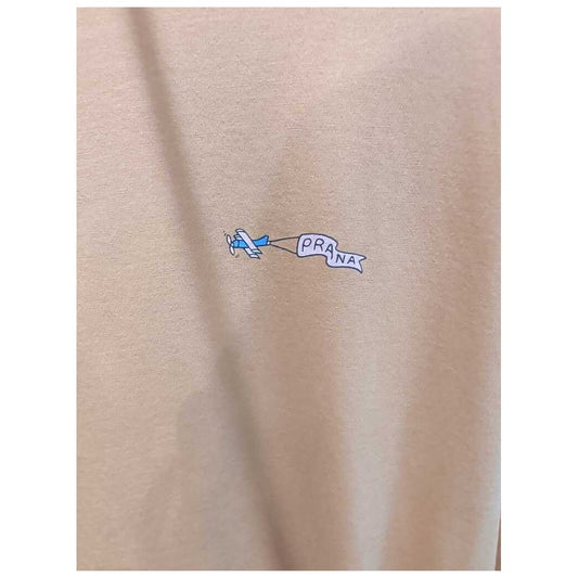 Close-up of the Prana Womens Everyday Graphic Oversized Tee-SAMPLE in Dijon Vacation showing the small airplane graphic on the fabric.